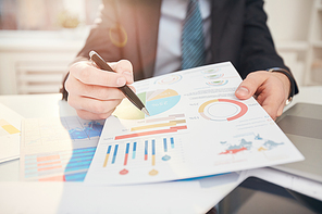 Fisheye view of unrecognizable businessman showing colorful data graph to camera, copy space