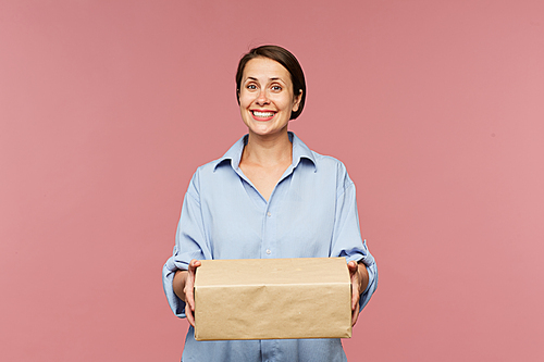 Young happy client of online shop with big packed box looking at you in isolation
