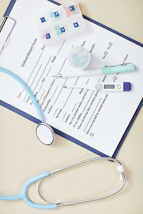 Top view background of medical form on clipboard with stethoscope over it, copy space healthcare concept