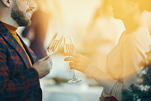 closeup of adult couple  champagne and talking during christmas banquet, golden lens flare overlay