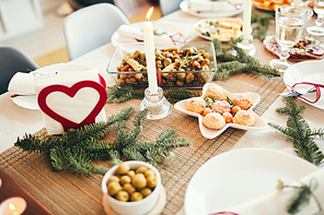 Background image of cozy table setting decorated with fir branches for Christmas banquet focus on freshly baked pastries, copy space