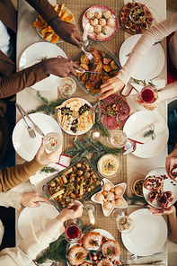 Above view background of people dining at festive Christmas table with delicious homemade food, copy space