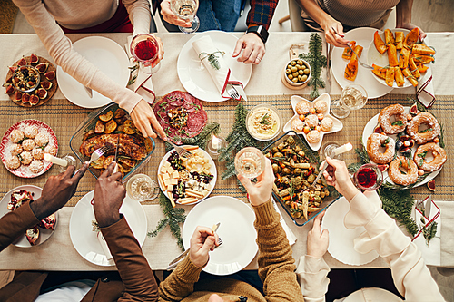 Top view background of people dining at festive Christmas table with delicious homemade food, copy space