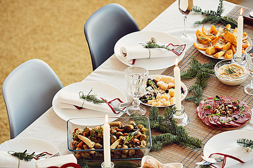 High angle view at beautiful table setting for Christmas party with rustic details and delicious homemade food, copy space