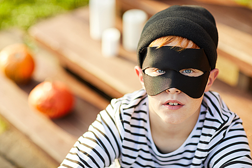 Closeup portrait of teenage boy wearing Halloween costume  while posing outdoors, copy space