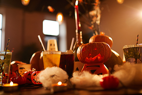 Halloween background of witches table with candles and pumpkins decor set for party in nightclub, copy space