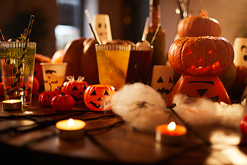 Halloween background of witches table with candles and pumpkins decorations set for party in nightclub, copy space