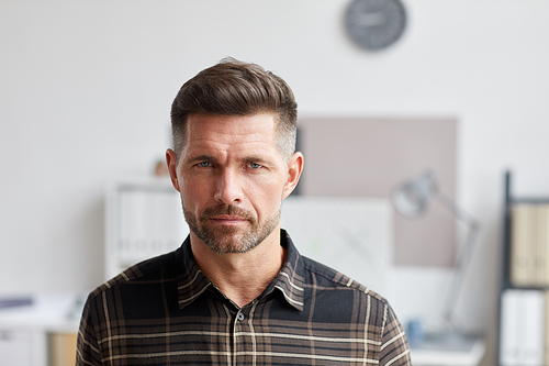 Close up portrait of mature bearded man  while standing in architects office, copy space