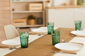 Background image of elegant table serving set for six guests in minimal kitchen interior, copy space