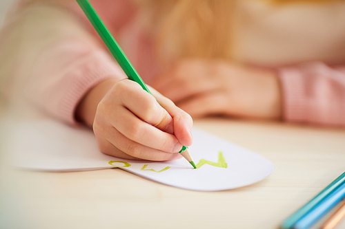 Close up of unrecognizable little girl making handmade card for Mothers day, copy space