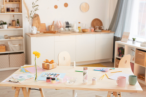 Warm-toned background image of cozy kitchen interior with wooden table in foreground, copy space