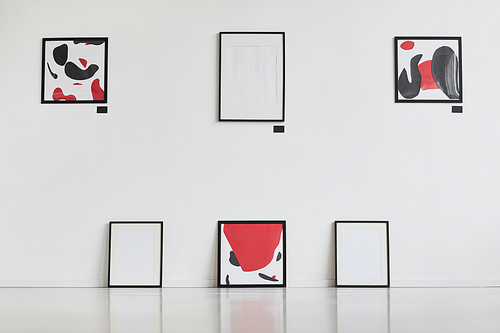 Graphic background image of modern abstract paintings with black and red hanging on white wall in art gallery exhibition, copy space