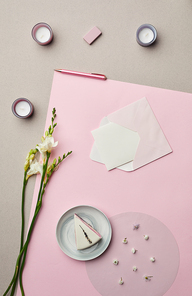 Minimal composition of letter in envelope over pink graphic background with floral decor, copy space