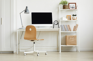 Full length view at minimal home office design with wooden chair and white computer desk against white wall, copy space