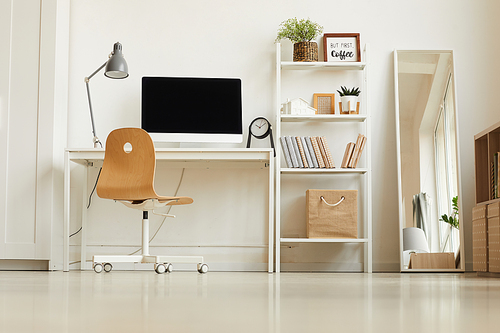 Low angle view at all-white modern interior with focus on empty home office workplace, copy space
