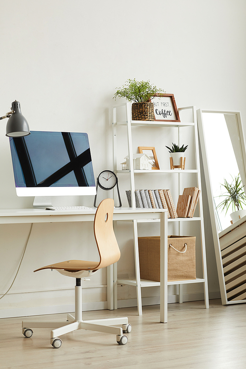 Vertical background image of empty home office workplace with wooden chair and modern computer on white desk, copy space