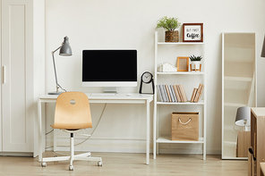 Clean background image of minimalistic apartment interior with focus on computer desk against white wall, copy space