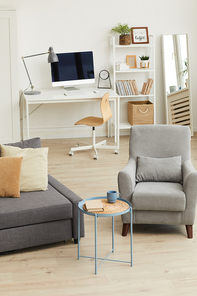 Vertical background image of cozy apartment interior in modern home with focus on grey living room furniture, copy space