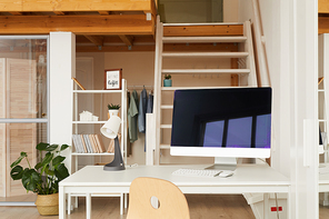 Background image of contemporary workplace in two level office apartment with computer desk in foreground, copy space