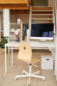 Vertical image of contemporary two level apartment interior with home office workplace in foreground, copy space
