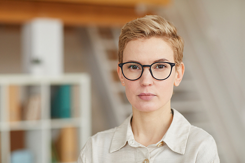 Head and shoulders portrait of confident businesswoman  while posing in office, copy space