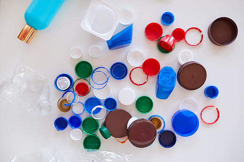 Top view background of various plastic items on white background, waste sorting and recycling concept, copy space
