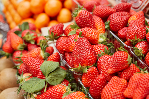 Background image of fresh ripe strawberries ready for sale at stand in farmers market, copy space