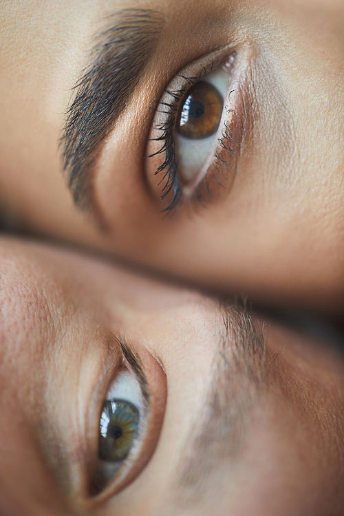 Extreme close up of male and female eyes , love and couple concept