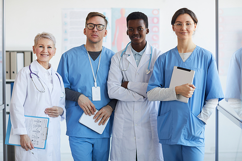 Multi-ethnic group of doctors  while posing together in clinic interior