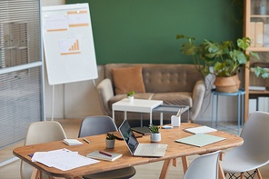 : Background image of contemporary eco-friendly office meeting room with green accent wall, copy space