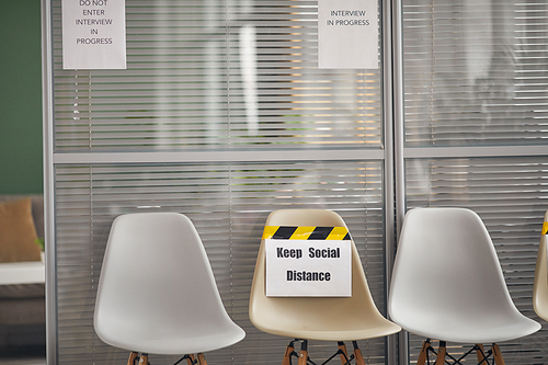 Background image of chairs in row with Keep social distance sign at waiting zone in office, copy space