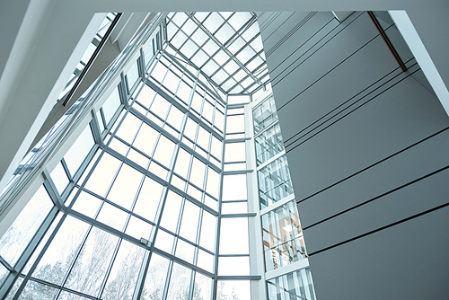 Glass wall and window of large contemporary business center or office building that is part of its interior