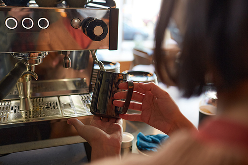 Close up of female barista making fresh coffee in cafe or coffee shop and pouring cream in latte, copy space