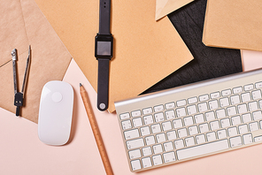 Horizontal from above flat lay conceptual shot of mess on office table, pale pink background