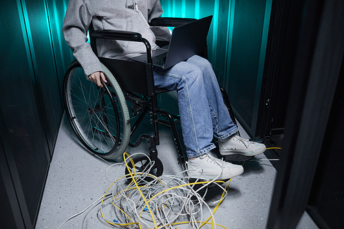 Cropped portrait of disabled woman working in server room and managing internet network, accessible job concept, copy space