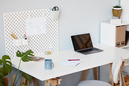 Minimal background image of cozy home office workplace in white decorated by plants, copy space