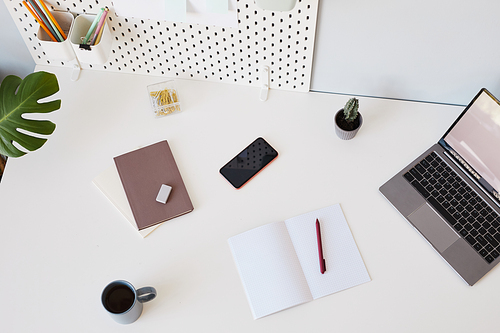 Top view background image of minimal white workplace with laptop and notebook, copy space