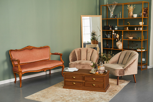 Background image of elegant salon interior with comfy velvet sofa and antique furniture in green tones