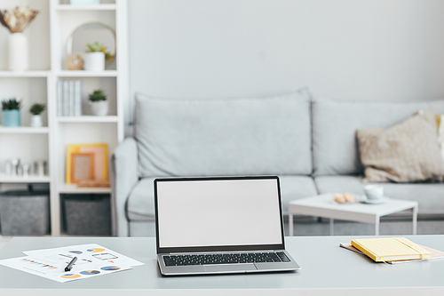 Minimal background image of home office workplace with laptop on desk in white airy interior, copy space