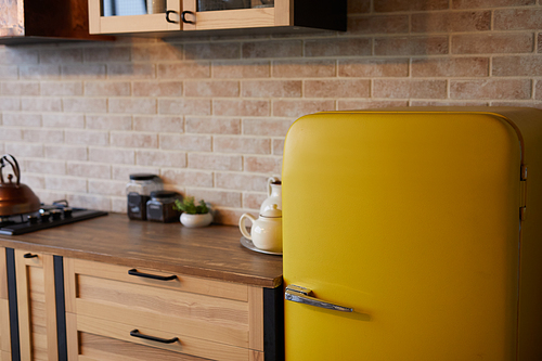 Background image of kitchen interior with brick wall and yellow retro fridge, copy space