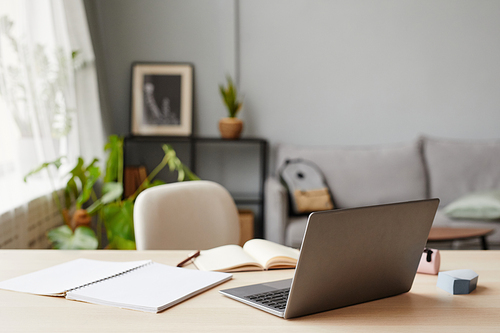 Background of home education workplace with laptop in foreground, copy space