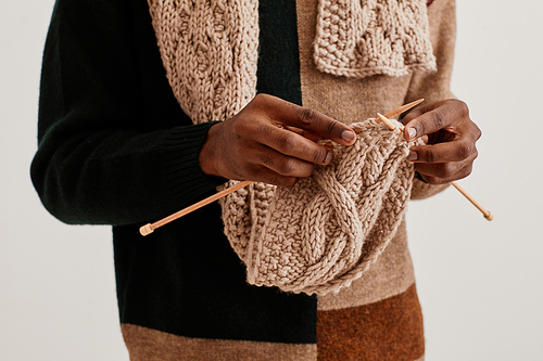 Minimal close up of unrecognizable African-American man knitting scarf, copy space