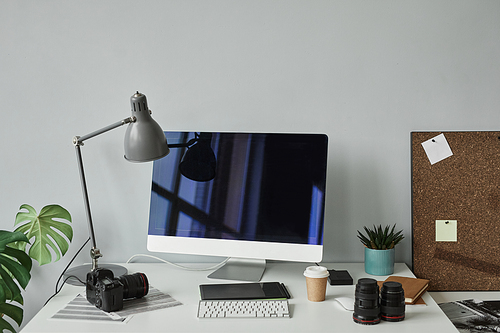 Minimal background image of photographers workplace with computer setup for photo editing, copy space