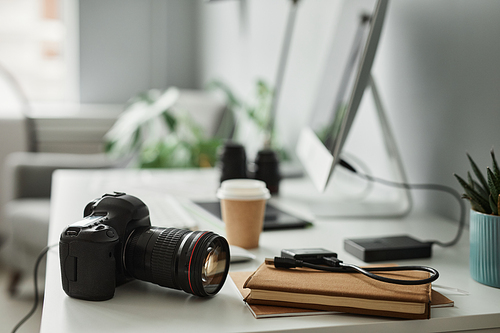 Close up of professional digital camera on desk at photographers workplace, copy space