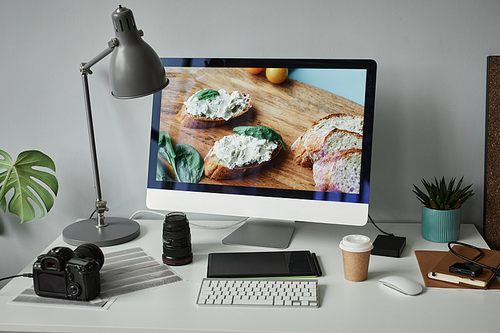 Background image of photographers workplace with computer screen for photo editing, copy space