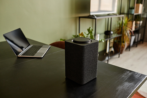 Background image of smart speaker with voice control home AI system on black table, copy space