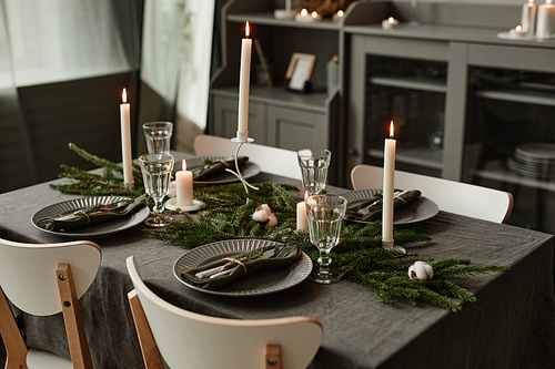 Background of elegant dining table decorated for Christmas in minimal grey tones, copy space