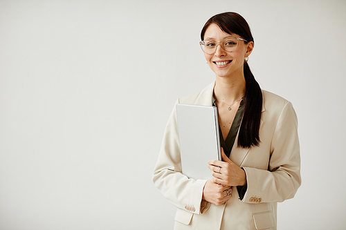 Minimal waist up portrait of smiling female entrepreneur on white, copy space