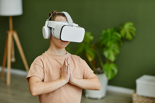 Minimal waist up portrait of tween girl practicing yoga workout in VR, copy space