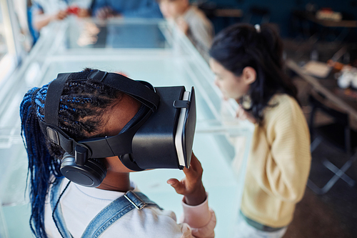High angle portrait of black teenage girl wearing VR headset in scince class at modern school